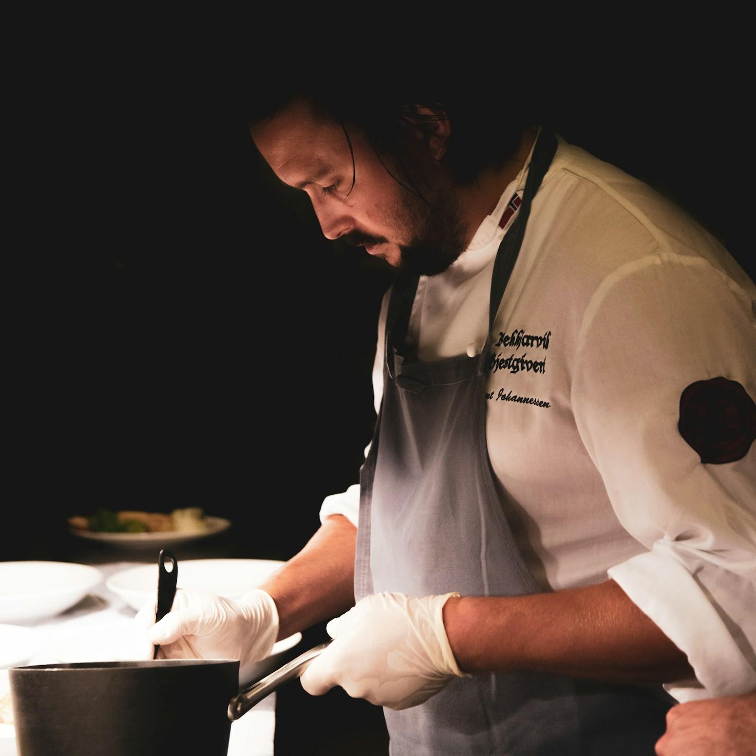 Diverse group of community members sharing a meal together, showcasing the social bonds formed through collaborative cooking